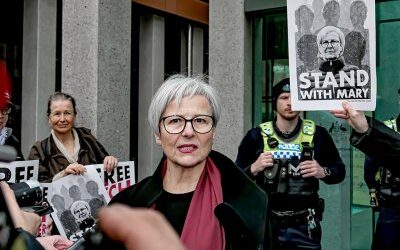 Pro-Palestine supporters stand with Mary Kostakidis